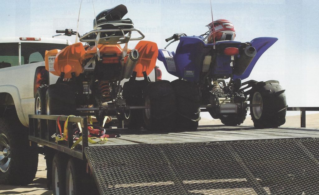 Vehicle with trailer and ATVs.